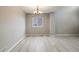 Bright open-plan living space features light wood flooring and neutral walls with a chandelier at 4821 N Silverlace Dr, Castle Rock, CO 80109