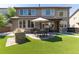Beautiful backyard features an outdoor kitchen, patio and artificial grass at 3791 Charterwood Cir, Highlands Ranch, CO 80126