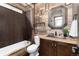 Bathroom with unique wood paneling detail, stone accents, and stylish fixtures at 3791 Charterwood Cir, Highlands Ranch, CO 80126