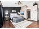 Bright bedroom featuring a ceiling fan, large windows and dark accent wall at 3791 Charterwood Cir, Highlands Ranch, CO 80126