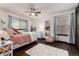 Comfortable bedroom featuring hardwood flooring, a ceiling fan, and large windows with plenty of natural light at 3791 Charterwood Cir, Highlands Ranch, CO 80126