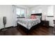 This bedroom features wood floors, natural light, and a plush comforter set at 3791 Charterwood Cir, Highlands Ranch, CO 80126