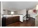 Hallway with dark wood floors, dark cabinets with light wood countertops and a staircase at 3791 Charterwood Cir, Highlands Ranch, CO 80126