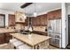 Gourmet kitchen featuring granite countertops, stainless steel appliances, custom cabinets, and a breakfast bar at 3791 Charterwood Cir, Highlands Ranch, CO 80126