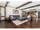 Open concept living room with dark hardwood floors, exposed wood beams, large windows and comfortable seating at 3791 Charterwood Cir, Highlands Ranch, CO 80126