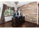 Home office featuring wood paneling, hardwood flooring and large windows allowing for natural light at 3791 Charterwood Cir, Highlands Ranch, CO 80126