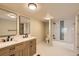 Modern bathroom with dual sinks, stylish lighting, and a sleek shower-tub combination at 311 Harrison Ave, Fort Lupton, CO 80621