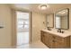 Bathroom featuring a double sink vanity, modern fixtures, and updated tile flooring at 311 Harrison Ave, Fort Lupton, CO 80621