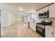 Open-concept kitchen featuring stainless steel appliances and access to the living room at 311 Harrison Ave, Fort Lupton, CO 80621