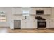 Kitchen featuring stainless steel appliances, white cabinets, and quartz countertops at 311 Harrison Ave, Fort Lupton, CO 80621