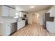 Modern kitchen with stainless steel appliances and white cabinets, perfect for cooking at 311 Harrison Ave, Fort Lupton, CO 80621