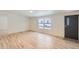 Inviting living room featuring new floors, a large window, and neutral wall color at 311 Harrison Ave, Fort Lupton, CO 80621