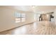 Bright living room features wood-look flooring and windows with natural light at 311 Harrison Ave, Fort Lupton, CO 80621