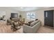 Bright living room with contemporary decor, wood flooring, and large windows providing ample natural light at 311 Harrison Ave, Fort Lupton, CO 80621