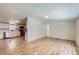 Bright open-concept living space with new floors, seamlessly flowing into the modern kitchen at 311 Harrison Ave, Fort Lupton, CO 80621