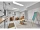 Bright basement featuring a kitchenette, tables, and unique school desks for versatile use at 12423 W 68Th Ave, Arvada, CO 80004