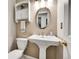 Bathroom with pedestal sink, classic fixtures, and decorative mirror and vanity lighting at 12423 W 68Th Ave, Arvada, CO 80004