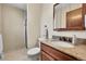 Well-lit bathroom with a granite countertop, tile flooring, and shower at 12423 W 68Th Ave, Arvada, CO 80004