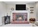 Close-up of the fireplace with brick surround and mantel, creating a cozy focal point at 12423 W 68Th Ave, Arvada, CO 80004