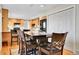 Open kitchen area with a dining table, black chairs, and modern appliances at 12423 W 68Th Ave, Arvada, CO 80004
