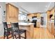 Beautiful kitchen with wooden cabinets, granite countertops, and a breakfast bar with seating for two at 12423 W 68Th Ave, Arvada, CO 80004