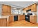 Well-appointed kitchen with wood cabinets, black appliances, and plenty of natural light at 12423 W 68Th Ave, Arvada, CO 80004