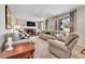 Inviting living room featuring a brick fireplace, comfortable seating, and natural light at 12423 W 68Th Ave, Arvada, CO 80004