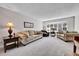 Spacious living room with large windows, plush sofas, and neutral decor creating a warm and inviting atmosphere at 12423 W 68Th Ave, Arvada, CO 80004