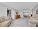 Open-concept living room with a piano, doorway to the staircase, and dining area view at 12423 W 68Th Ave, Arvada, CO 80004