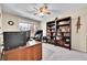 Well-lit home office with a large desk, bookshelves, and a comfortable chair, perfect for remote work at 12423 W 68Th Ave, Arvada, CO 80004