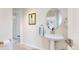 Clean powder room with pedestal sink and oval mirror at 10886 Pheasant Run, Littleton, CO 80125