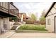Spacious backyard featuring a lush lawn, concrete patio, wooden fence and stairs to deck area at 4828 W 32Nd Ave, Denver, CO 80212
