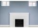 Unfinished basement featuring a white-painted brick fireplace, ready for customization at 4828 W 32Nd Ave, Denver, CO 80212