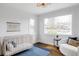Bright Bedroom featuring hardwood floors, a light wood crib, natural light, and stylish decor at 4828 W 32Nd Ave, Denver, CO 80212