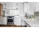 Bright, renovated kitchen with stainless appliances, granite counters and modern white cabinets at 4828 W 32Nd Ave, Denver, CO 80212
