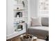 Close up view of a stylishly decorated built-in bookshelf and comfy couch in a well-lit living room at 4828 W 32Nd Ave, Denver, CO 80212