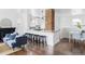 Bright living room featuring a fireplace, hardwood floors and views into the kitchen at 4828 W 32Nd Ave, Denver, CO 80212