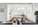 Stylish living room featuring an open floor plan, hardwood floors, and large windows at 4828 W 32Nd Ave, Denver, CO 80212