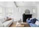 Bright living room with modern decor, a cozy fireplace, and large windows providing ample natural light at 4828 W 32Nd Ave, Denver, CO 80212