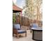 Relaxing patio area with wooden chairs and a modern fire pit, ideal for enjoying evenings outdoors at 4828 W 32Nd Ave, Denver, CO 80212