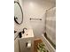 Bright bathroom with modern vanity, stylish mirror, shower with curtain and wooden flooring at 3127 W 28Th Ave # 2, Denver, CO 80211