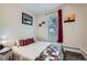 Comfortable bedroom with a plush bed, colorful accents, and natural light from the window at 3127 W 28Th Ave # 2, Denver, CO 80211