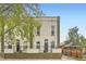 Charming building exterior with arched windows, iron fence and mature shade tree at 3127 W 28Th Ave # 2, Denver, CO 80211