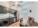 Bright kitchen featuring stainless steel appliances and a dining area illuminated by a window at 3127 W 28Th Ave # 2, Denver, CO 80211