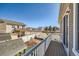 A spacious back deck overlooks a backyard with a playset and a white fence on a sunny day at 5534 Killarney St, Denver, CO 80249