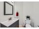 Powder room featuring updated vanity with marble countertop and fixtures at 5534 Killarney St, Denver, CO 80249