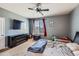 Bedroom featuring a ceiling fan, a TV and a large window that provides natural light at 5534 Killarney St, Denver, CO 80249