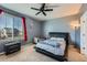 Bedroom featuring a ceiling fan and large window that provides natural light at 5534 Killarney St, Denver, CO 80249