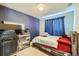 Bedroom featuring rustic wood accents and calming blue walls at 5534 Killarney St, Denver, CO 80249