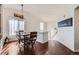Bright dining room with hardwood floors, and a modern chandelier at 5534 Killarney St, Denver, CO 80249